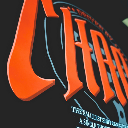 Black oversized hoodie with 'DRIVEN BY CHAOS' in large red letters gothic font within a car steering wheel design