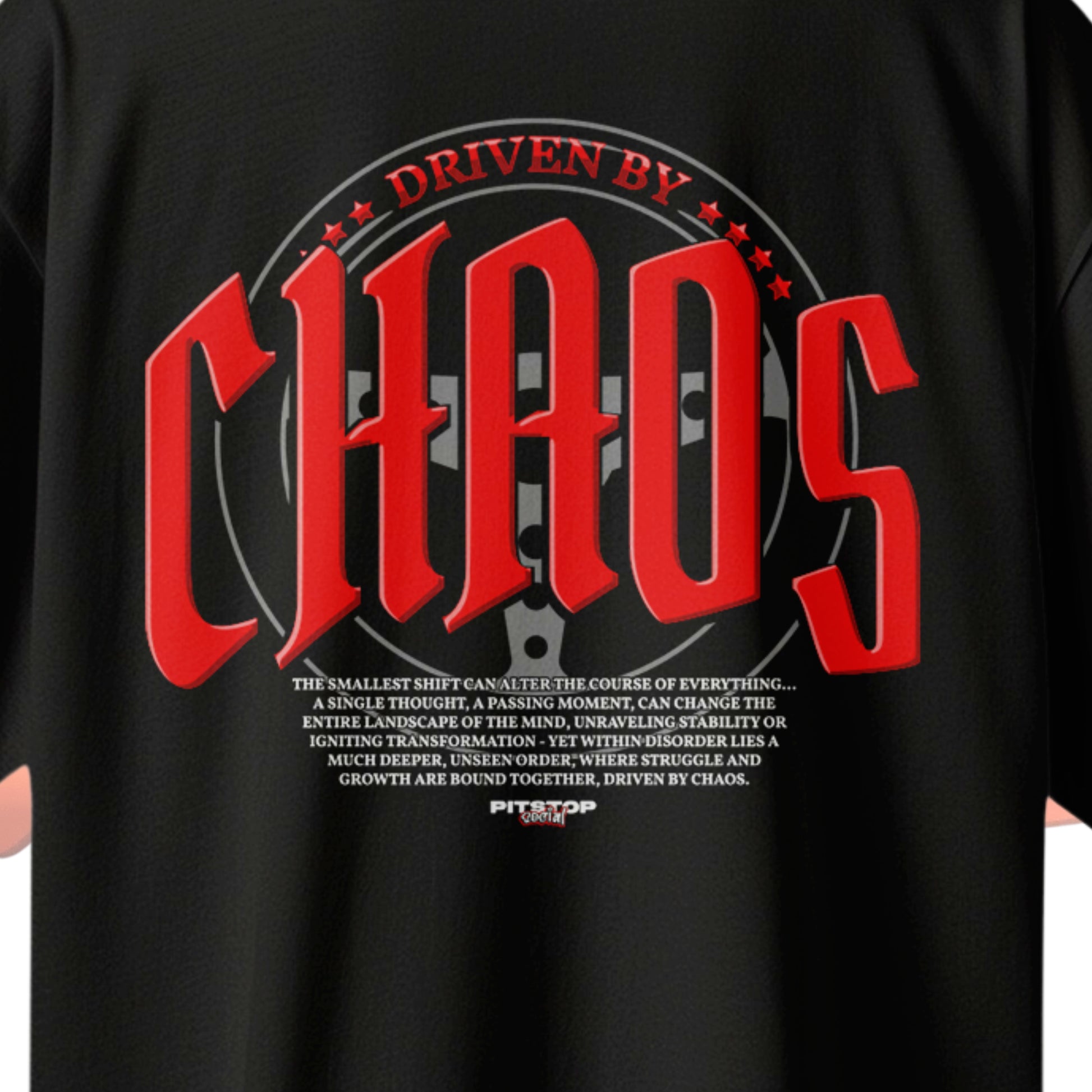 A black premium t-shirt with the text 'DRIVEN BY CHAOS' printed in large red letters on the back and steering wheel design