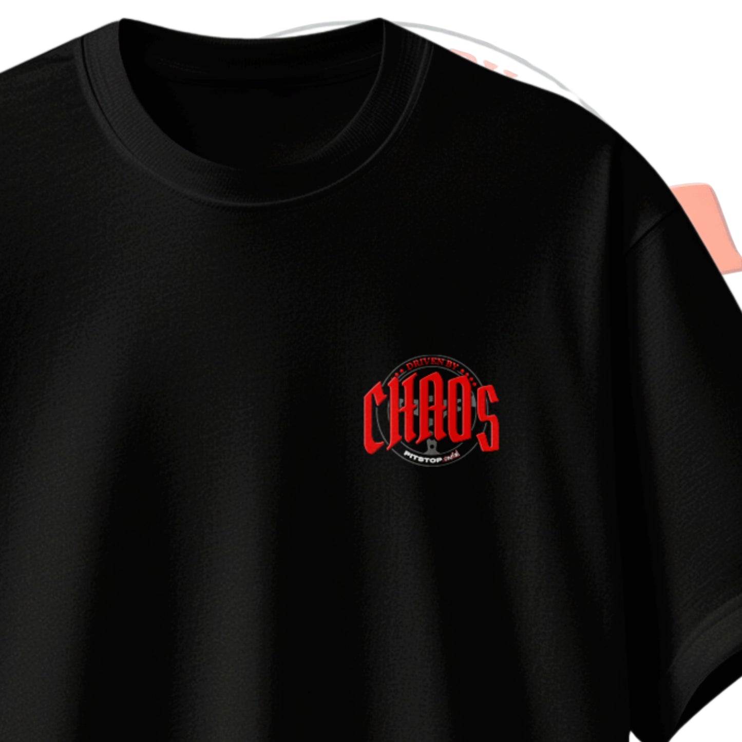 A black premium t-shirt with the text 'DRIVEN BY CHAOS' printed in red letters with steering wheel design chest logo