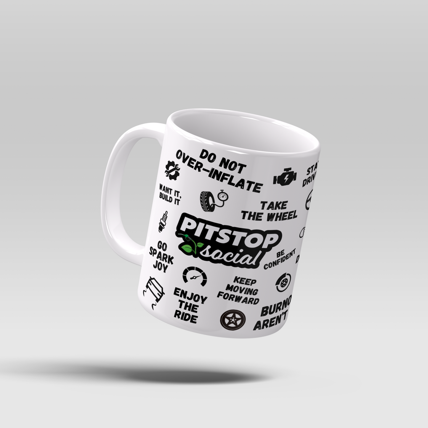 A white ceramic mug with 3D raised text and graphics including the Pitstop Social logo, car symbols, and mental health and wellbeing messages of motivation