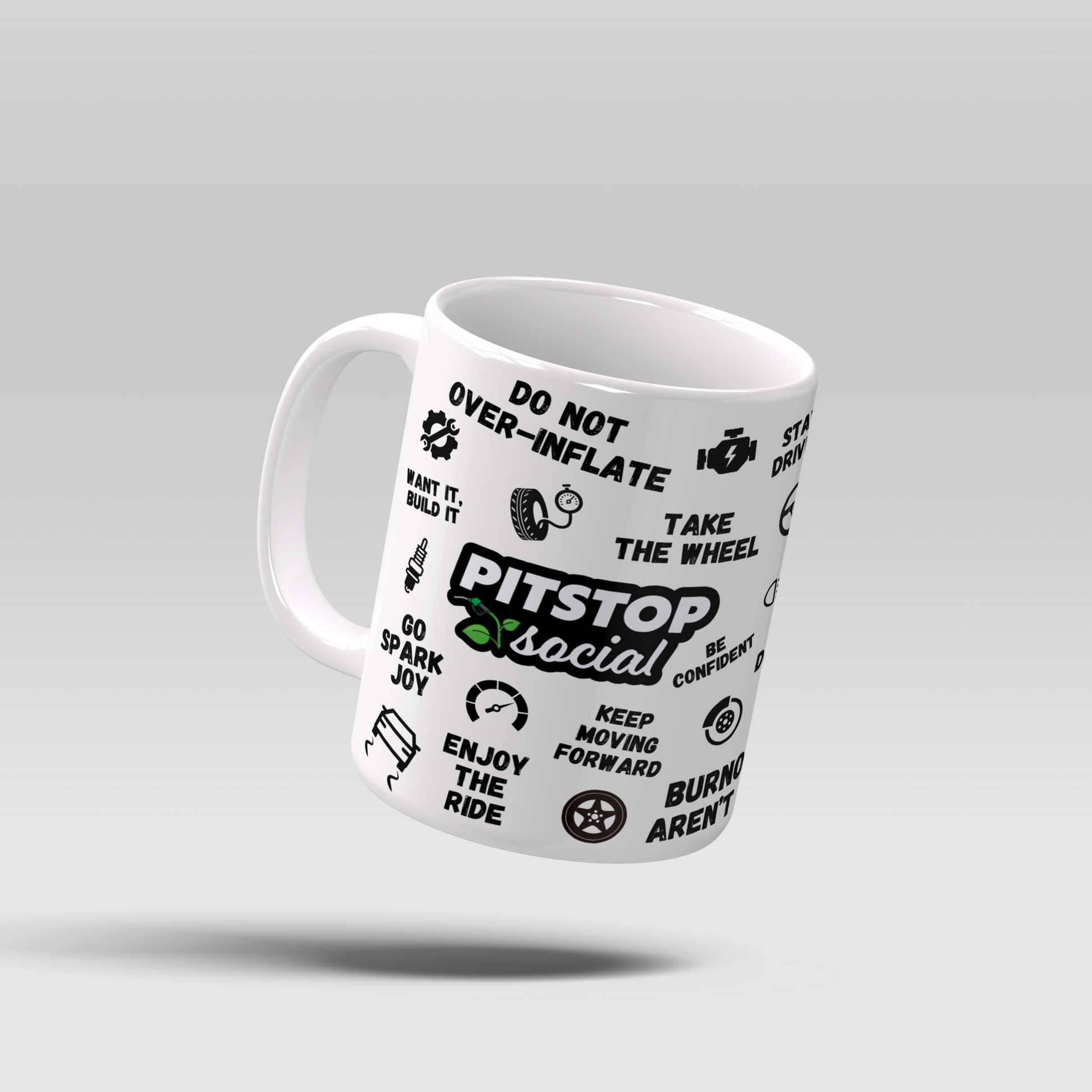 A white ceramic mug with 3D raised text and graphics including the Pitstop Social logo, car symbols, and mental health and wellbeing messages of motivation