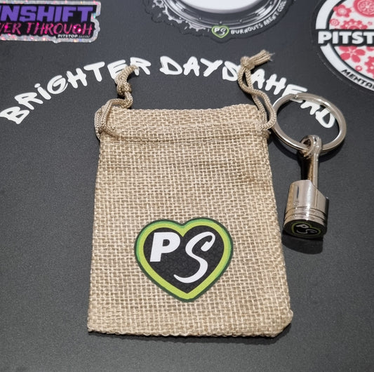 solid metal piston key chain fidget with PITSTOP.Social branded gift bag