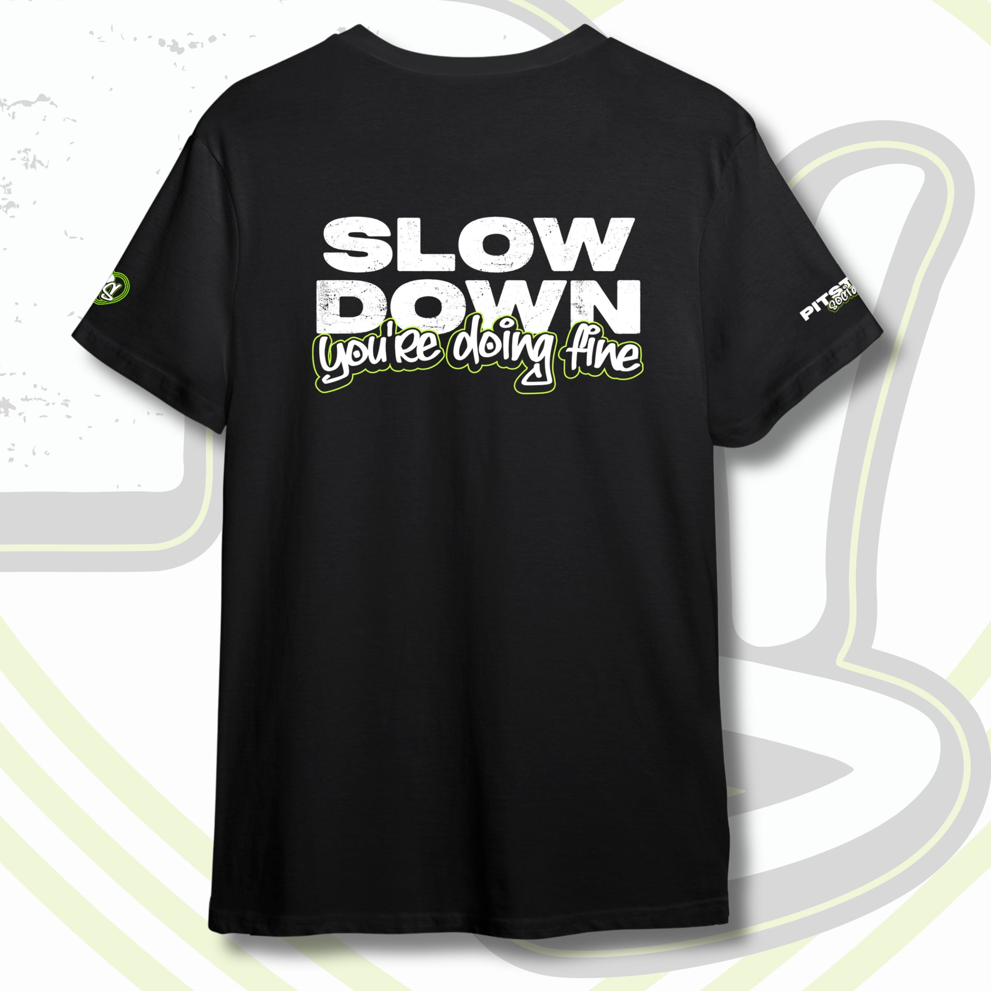 Black graphic t-shirt with graffiti text "SLOW DOWN You're Doing Fine" with green outline and PITSTOP.Social logo on sleeves